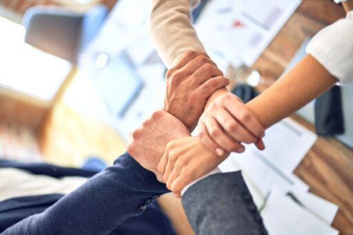 person in black long sleeve shirt holding persons hand